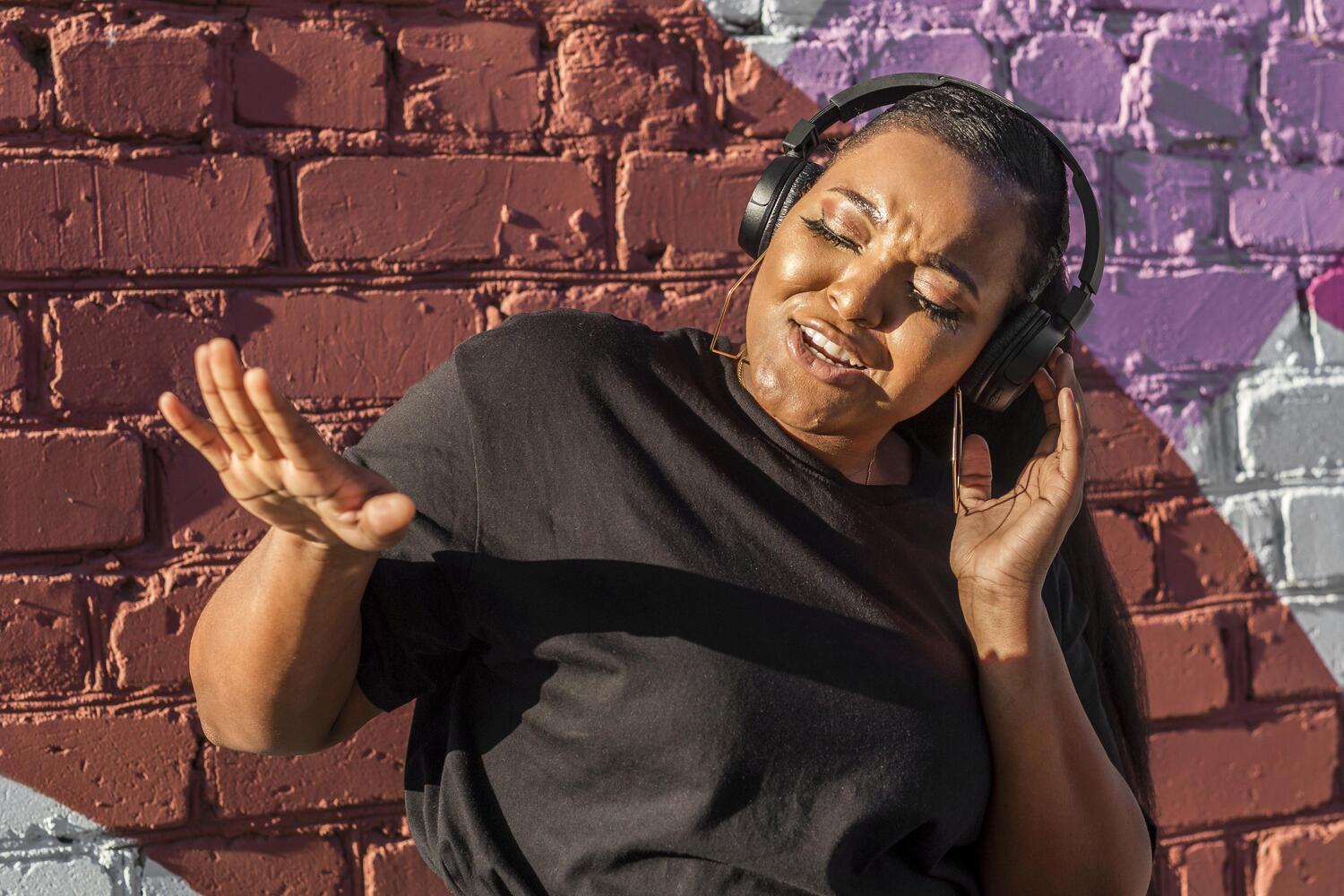 teenager-girl-listening-music-through-headphones-outside